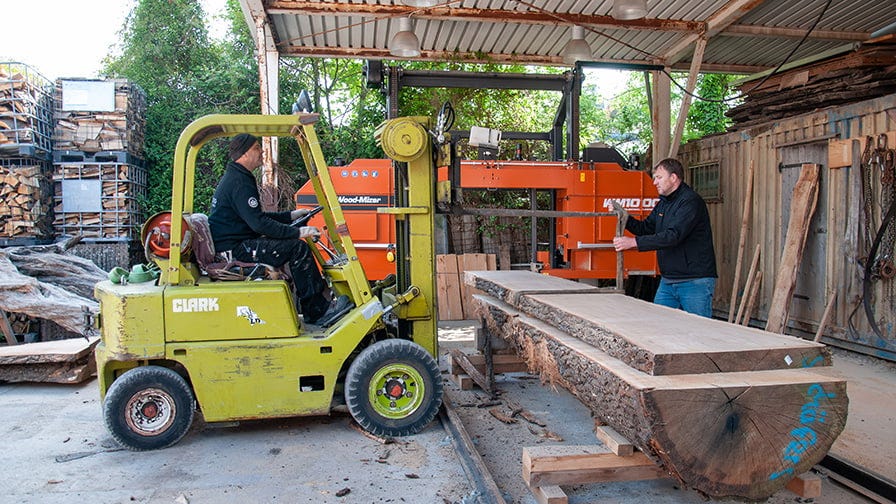The forklift removes a heavy board